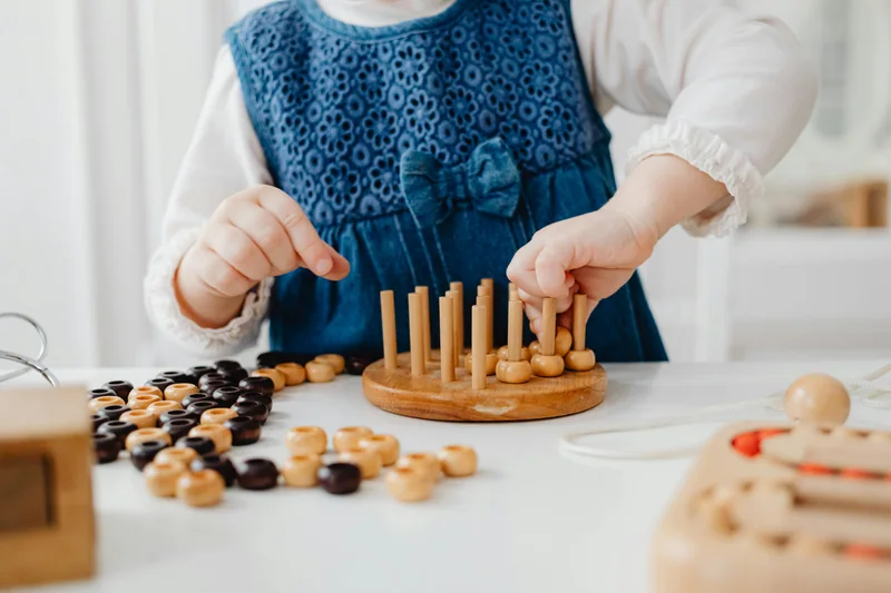 Niño de preescolar explorando juguetes de madera